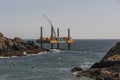 Offshore work platform. Covering a submerge outfall pipe with concrete. Cornwall, UK Royalty Free Stock Photo