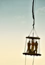 Offshore worker inside personal safety basket hanging in the air