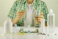 Boy siting at the table with contact lenses, eye drops, supplements and vitamins