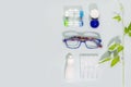 Eyeglasses, containers with contact lenses, eye drops and copy space Royalty Free Stock Photo