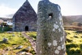 Ogham stone and Kilmalkedar medieval church Royalty Free Stock Photo