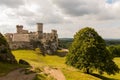 Medieval castle ruins on the green hill Royalty Free Stock Photo