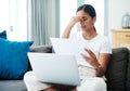 Oh dear. I overspent this month. a young woman sitting on her sofa and feeling stressed while calculating her finances Royalty Free Stock Photo