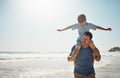 Oh happy days. a father carrying his little son on his shoulders at the beach. Royalty Free Stock Photo