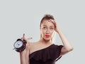 Oh, I forgot to change the time I got a date and it is already late. Young woman holding alarm clock stressed running late Royalty Free Stock Photo