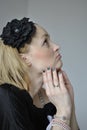 Beautiful young woman with black flower in her hair