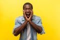 Oh my god, wow! Portrait of stunned shocked man holding hands on face and looking with big amazed eyes. indoor studio shot