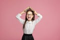 Oh no, i hate to study. Schoolgirl in uniform and glasses screams and holds book on her head