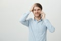 Oh no, it slipped my mind. Studio shot of attractive young entrepreneur in casual shirt punching forehead with palm and