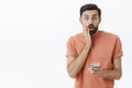 Oh no, wrong number. Portrait of man accidently sent message via smartphone wrong person touching face and open mouth