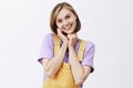 Oh you are so sweet. Charmed and pleased tender girlfriend with blond short haircut wearing yellow dungarees, tilting