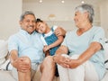 Ohana means family and family means nobody gets left behind. grandparents bonding with their granddaughter on a sofa at