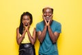 Ohh God. Portrait of a surprised young afro american couple screaming isolated over yellow background Royalty Free Stock Photo