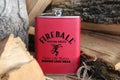 Ohio, USA-Jan 25, 2017: Fireball flask standing on a wood pile. Best selling cinnamon flavored whiskey made in Canada- illustrativ