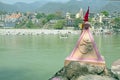 Ohm sign on a rock at the holy river Ganga near Rishikesh in India