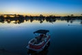 Ohmas Bay Sunset with Red Pontoon Boat Royalty Free Stock Photo