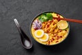 Ohn No Khao Swe in black bowl at dark slate background. Oh No Khao Suey is Coconut Milk Noodle Soup of myanmar cuisine Royalty Free Stock Photo