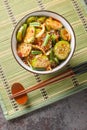 Oi muchim is a Korean spicy cucumber salad closeup on the bowl. Vertical top view