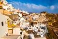 Oia castle ruins, Santorini, Greece and Oia village before sunset Royalty Free Stock Photo