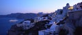Oia Santorini at night with illuminated cruise ship in the caldera. Royalty Free Stock Photo