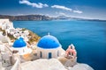 Oia town on Santorini island, Greece. Traditional and famous houses and churches with blue domes over the Caldera.