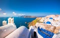 Oia town on Santorini island, Greece. Traditional and famous houses and churches with blue domes over the Caldera, Aegean sea Royalty Free Stock Photo