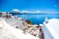 Oia town on Santorini island, Greece. Traditional and famous houses and churches with blue domes over the Caldera.