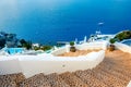 Oia town on Santorini island, Greece. Traditional and famous houses and churches with blue domes over the Caldera.