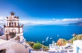 Oia town on Santorini island, Greece. Traditional and famous houses and churches with blue domes over the Caldera, Aegean sea