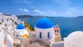 Oia town on Santorini island, Greece. Traditional and famous houses and churches with blue domes over the Caldera, Aegean sea Royalty Free Stock Photo