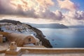 Oia town on Santorini island, Greece. Traditional and famous houses and churches with blue domes over the Caldera. Royalty Free Stock Photo