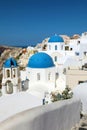 Oia town on Santorini island, Greece. Traditional and famous white houses and churches with blue domes over the Caldera, Aegean Royalty Free Stock Photo