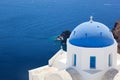 Oia town on Santorini island, Greece. White church with blue dome. Royalty Free Stock Photo