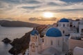 Oia village with churches against sunset on Santorini island in Greece Royalty Free Stock Photo