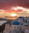 Oia village with churches against sunset on Santorini island in Greece Royalty Free Stock Photo