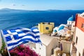 Oia village with famous white houses, bougainvillea flower and blue dome churches on Santorini island, Aegean sea, Greece. Greece Royalty Free Stock Photo