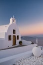 Oia village Santorini with blue domes and whitewashed house during sunset at the Island of Santorini Greece