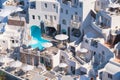 Oia village, Santorini, Greece. Architectural background. View of traditional houses in Santorini. Small narrow streets and roofto