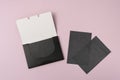 Oil-absorbing sheets or face wipes to remove excess oil on oily face. Pack of black blotting paper on violet background