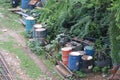 Oil barrels kept on the open ground. Big metallic drums to store crude oil and diesel for electricity generators