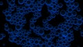 Oil blue drops in water. Abstract black background. Macro shot of various air bubbles in water rising up on light dark background Royalty Free Stock Photo