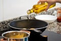 Oil from bottle into frying pan Royalty Free Stock Photo