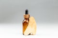 Oil bottle and gua sha wooden massager over gray Royalty Free Stock Photo