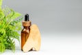 Oil bottle and gua sha wooden massager over gray Royalty Free Stock Photo