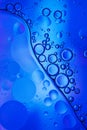 Oil bubbles in water . Blue and black colors tog hater. Royalty Free Stock Photo