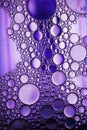 Oil bubbles in water. red and purple colors. Royalty Free Stock Photo