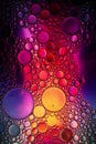 Oil bubbles in water. Yellow, red and purple colors. Royalty Free Stock Photo