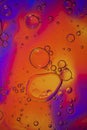 Oil bubbles in water. Yellow, red and purple colors                                          rs. Royalty Free Stock Photo