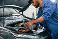 Oil can in hands. Auto mechanic working in garage. Repair service Royalty Free Stock Photo