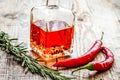 oil in carafe with spices and chili on wooden background mock-up